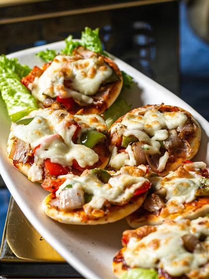 Our mini pizzas are a party favorite, topped with melting cheese and a variety of fresh vegetable toppings.