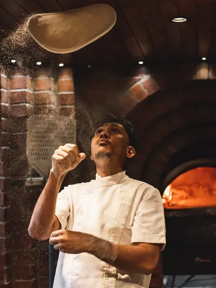 Watch our pizzaiolos put on a show. Every pizza base is hand-stretched from our 72-hour fermented sourdough, showcasing the skill and theatre we bring to your party.