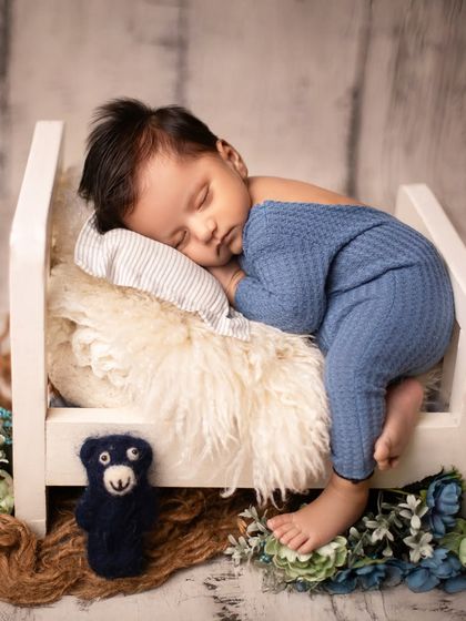 The "tummy time" pose on a tiny bed, showing the baby's cute profile and back rolls. Safety and comfort are always my top priorities in every pose.