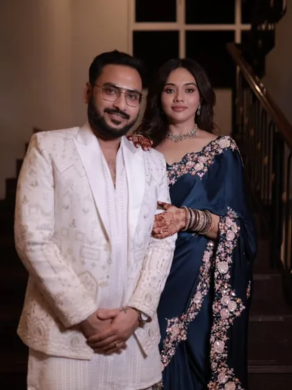 Another beautiful portrait of the couple. The drape of the saree looks elegant and timeless against the classic backdrop.