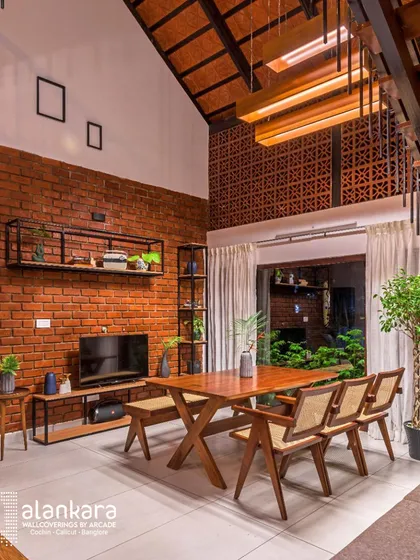 This space is a celebration of modern Keralite architecture. I combined exposed brick walls and traditional terracotta tiles with sleek, custom-made wooden furniture and light, airy curtains to create a home that is both rooted in tradition and contemporary in spirit.
