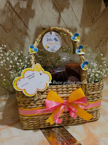 Another beautiful Kauna grass basket, filled with goodies and decorated with baby's breath and custom tags for a first birthday.