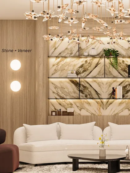 Stone + Veneer: Pairing stone with wood veneer brings depth and grounded elegance. In this living room, a marble display wall is beautifully complemented by warm wood paneling.