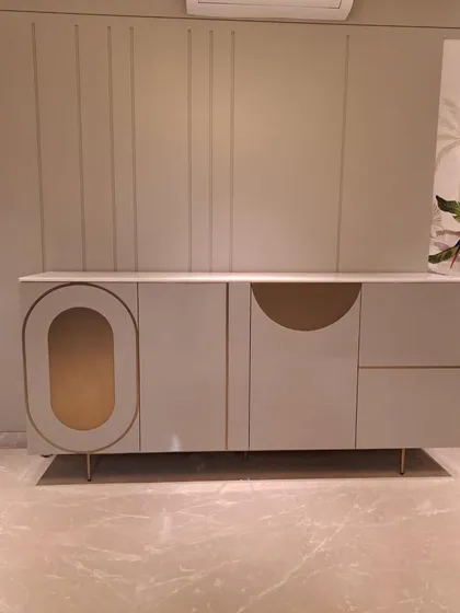 A casually chic console table with a high-gloss finish and unique geometric brass inlay, shown here in a client's home.