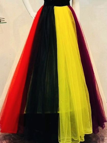 A bold and colorful gown with a black bodice and a skirt made of red, black, yellow, and purple tulle panels. A great rental for a creative or themed party.