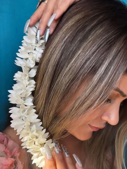 A profile view of the black heart and silver glitter nails, showing how they complement the client's style.