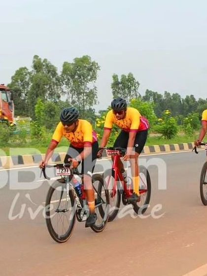 Three riders from the Cyclopedia cycling academy, showing their team colors and unity.