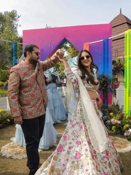 A fun and candid moment from a pre-wedding event. I styled the bride in a floral Seema Gujral lehenga and the groom in a complementary floral bandhgala by Anita Dongre.