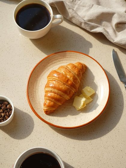 Sometimes, simplicity is best. A freshly baked, flaky croissant served with butter and a cup of our freshly ground Arabica coffee is one of life's great pleasures.
