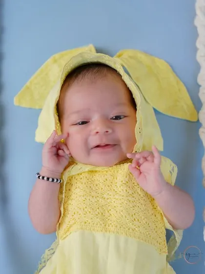 A sweet, sleepy smile from this newborn bunny. Close-up shots like this capture the delicate features and expressions of a new baby.