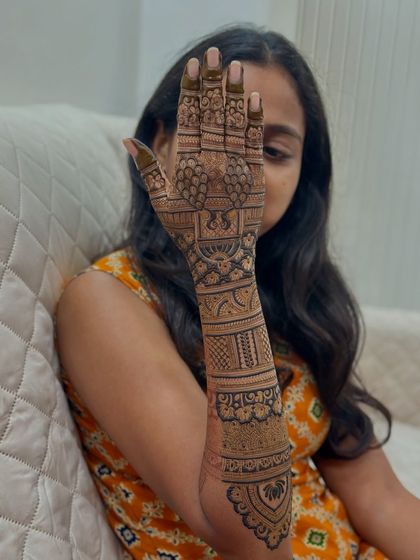 My student practicing the design on her own hand after the demo. Practice is key!