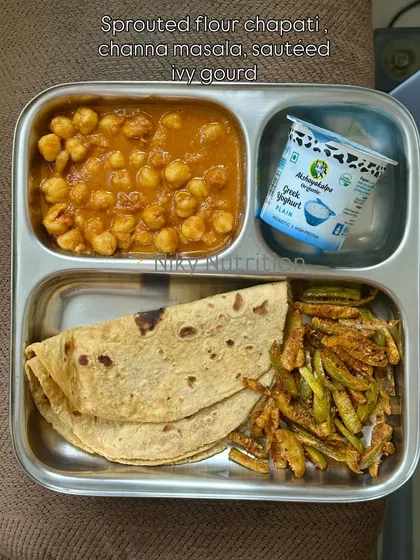 This plate features sprouted flour chapati, channa masala, sautéed ivy gourd, and Greek yogurt. It's a well-balanced meal that's great for gut health.
