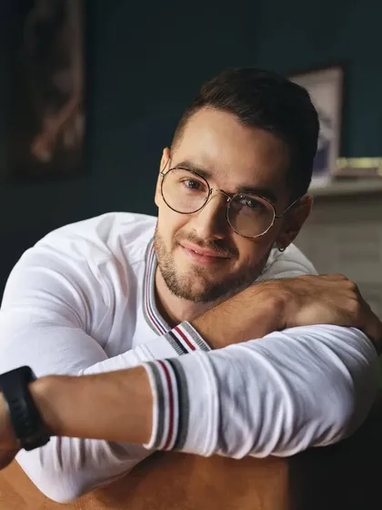 A close-up portrait from a Basics Life shoot. The simple white long-sleeve tee with striped collar detail is a subtle but stylish piece that shows how we focus on small details to elevate a look.