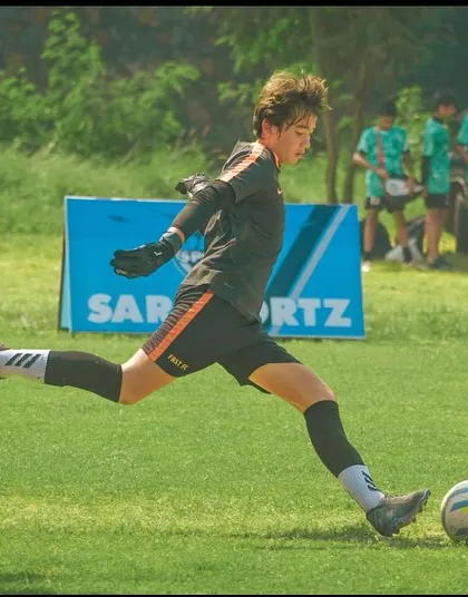 Our goalkeeper makes a clean kick to clear the ball during a U13 Pride Cup match.