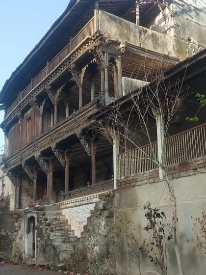 The ruins of the 18th-century Darbargarh in Sihor, Gujarat, with its stunning but decaying timber balconies, presenting a complex restoration challenge.