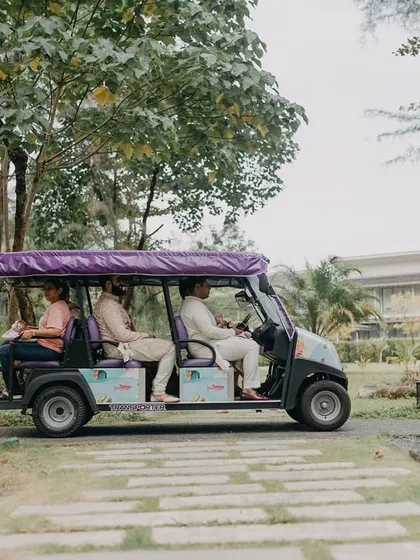 A fun, candid shot of the wedding party moving around the resort in a golf cart. These are the small, in-between moments that add character to the wedding album.