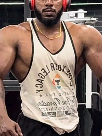 A close-up of the client's physique after his successful bulking phase, showing impressive size in his shoulders and arms.