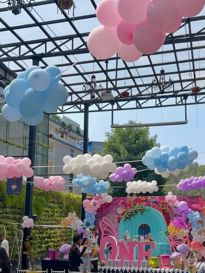 To make the venue feel even more like Wonderland, I hung balloon clouds from the ceiling, creating a dreamy, surreal sky above the main party area.