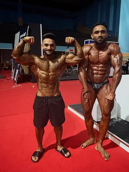 Two champions. Posing with a fellow competitor backstage. Respect for everyone who steps on that stage.