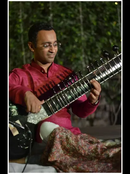 A smiling portrait from the same event, enjoying the musical moment.
