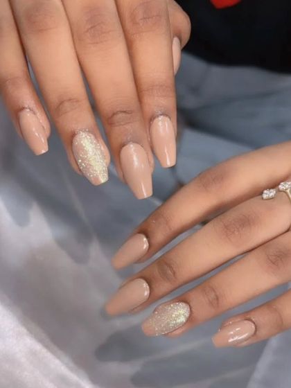 A simple and elegant set with nude polish and a gold glitter accent nail.