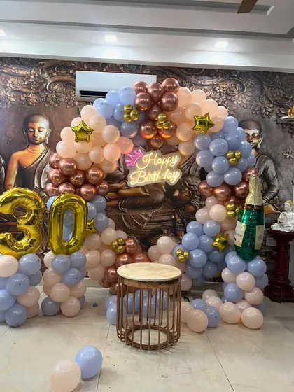 The beautiful blend of pastel and metallic balloons creates a stylish backdrop for this milestone birthday.