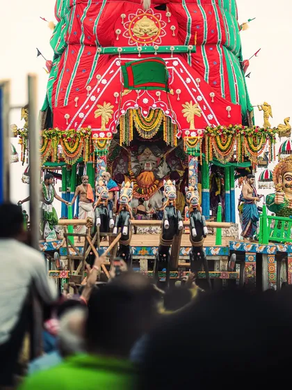 A close-up view of the magnificent chariot of Lord Jagannath, intricately decorated and surrounded by priests and devotees.