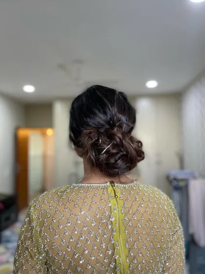 A soft and elegant messy bun created with just a few rhinestone pins for a touch of sparkle. This is a great option for a bridesmaid or wedding guest.
