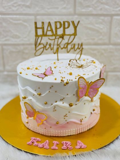 A full view of the elegant pink and white butterfly birthday cake.