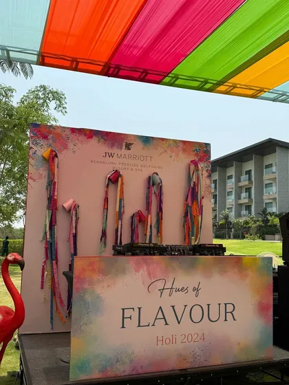 A closer look at the custom-branded DJ console and backdrop for the Holi 2024 event.