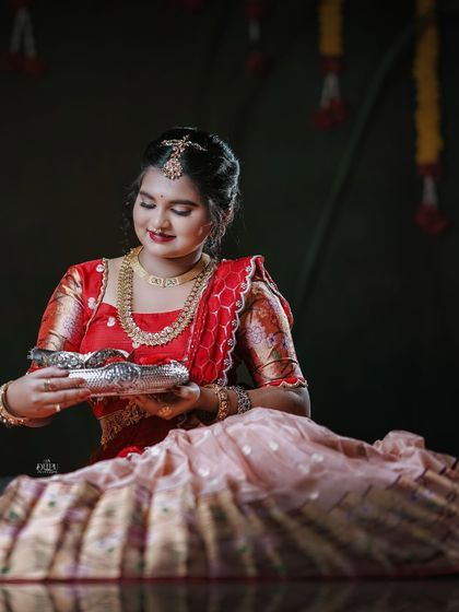 For the Makara Sankranthi festival, I designed this exquisite Zari Kota lehenga for my client. The peach skirt with a traditional border is paired with a red brocade blouse, creating a vision of grace and tradition.