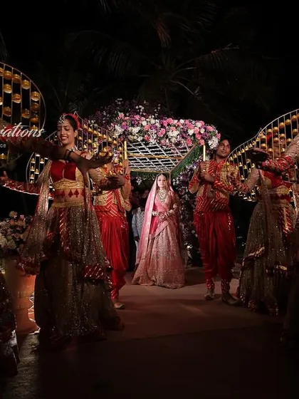 A beautiful bride entry at a Goa beach wedding. Dancers in traditional attire with elaborate props create an elegant and culturally rich procession for the bride.