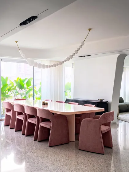 Color and form are central to our storytelling. For the dining area in Apartment 56, we custom-designed these volumetric, velvet-upholstered chairs and a matching pink table to introduce warmth and bold character into an otherwise minimal, open-plan space.