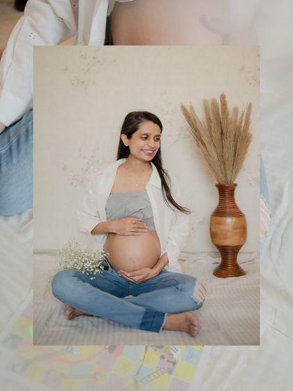 A relaxed, seated portrait of the mom-to-be. The casual outfit of jeans and a simple top shows that you should wear whatever makes you feel comfortable and beautiful.