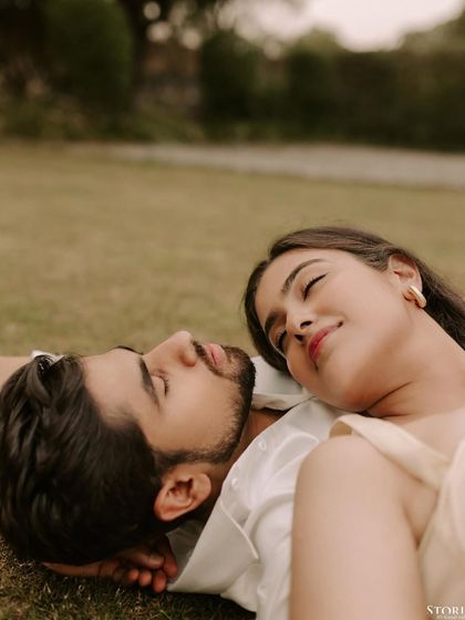A serene and intimate moment with the couple lying on the grass. This perspective offers a unique and peaceful portrait of togetherness.