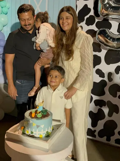 A happy family moment at the farm-themed party, complete with a custom cake that matches the rustic, countryside vibe.