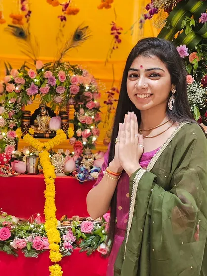 'Nand ke anand bhayo, Jai Kanhaiya Laal ki'. A moment of gratitude in front of a beautifully decorated Krishna jhanki for a Janmashtami event.