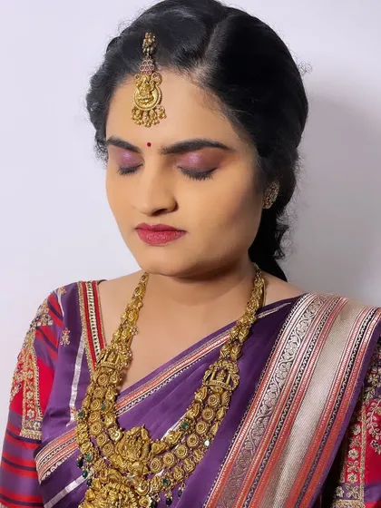 A close-up of a minimal yet elegant bridal look. The bride preferred a softer approach, so I used a wash of purple on the eyes and a muted berry lip to match her beautiful silk saree.