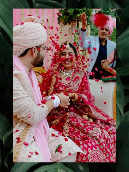 A candid moment of joy during the wedding ceremony, as the couple is showered with rose petals by their loved ones.