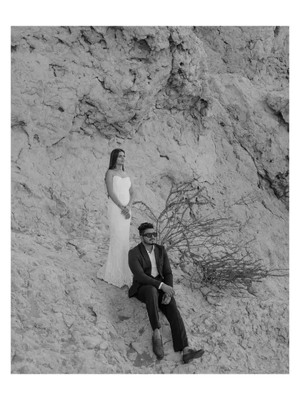 A minimalist black and white portrait set against the rocky textures of the Dubai landscape. The simple composition and timeless editing style put the focus entirely on the couple's presence and connection.