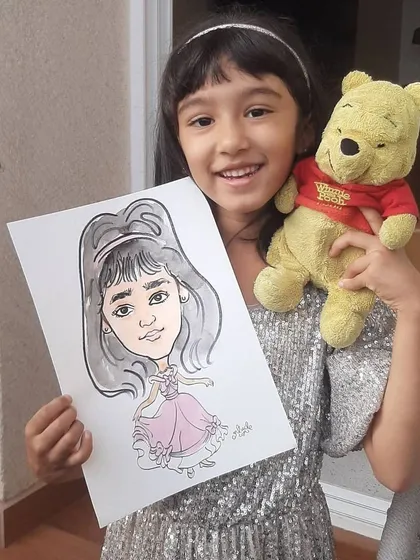 The perfect birthday party favor! This happy little girl is holding her custom princess caricature, a unique and personal keepsake to make her feel special on her big day.