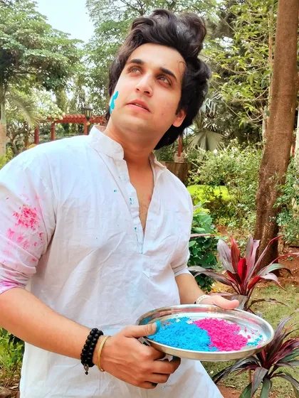 Celebrating Holi in a classic white kurta, ready to play with colors. This image captures the essence of the festival and is perfect for campaigns related to Holi.