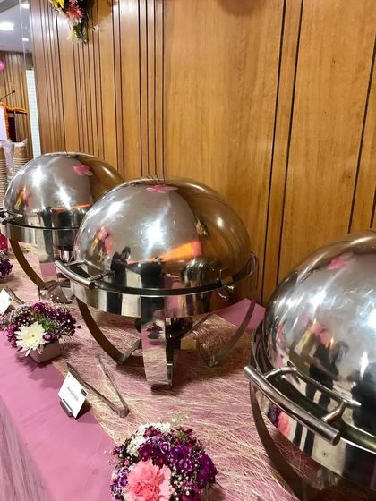 Another view of the Women's Day buffet. The shiny cloches and pink table runner created a cheerful and celebratory atmosphere for the special day.
