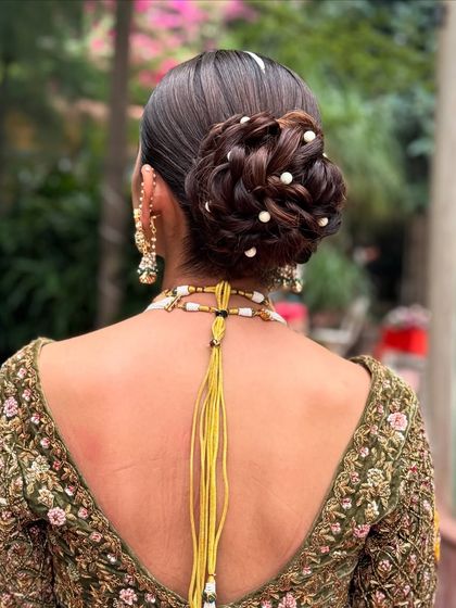 Another angle of the messy bridal updo, highlighting its structure and elegance.
