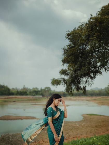 Another artistic shot of Mirnalini, capturing a moment of quiet reflection. The natural setting provides a perfect backdrop for her simple, elegant look.
