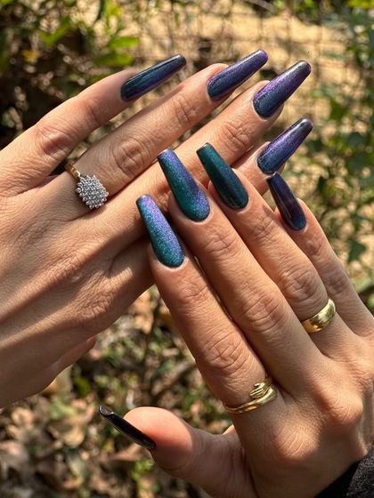 Another view of the long, coffin-shaped peacock nails, showing the full spectrum of color. This is a gel polish over acrylic extensions for maximum impact and durability.