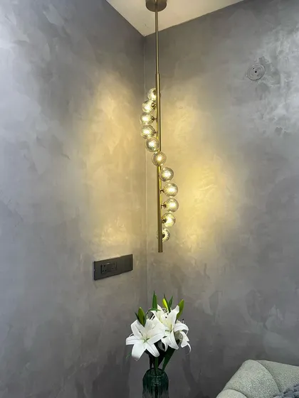 A spiral globe pendant installed in a client's home, adding a touch of modern elegance to the corner of their room.
