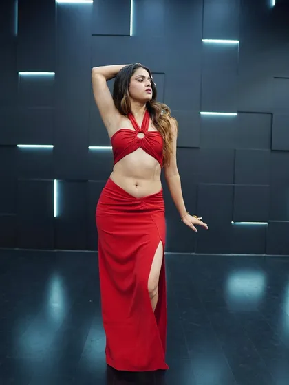 A full-length shot from a solo photoshoot in a stylish red outfit. This highlights my stage presence and confident posing.