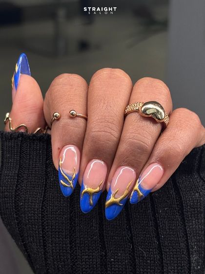 Another angle of the electric blue and gold flame nails. The raised texture of the gold paint adds an extra layer of dimension and luxury.