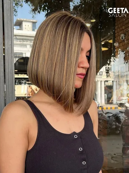 A sleek blonde bob with expertly placed highlights, creating a sharp and modern look.